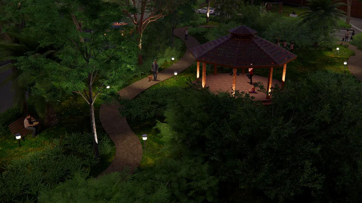 The park at night with lit pathways and a glowing gazebo